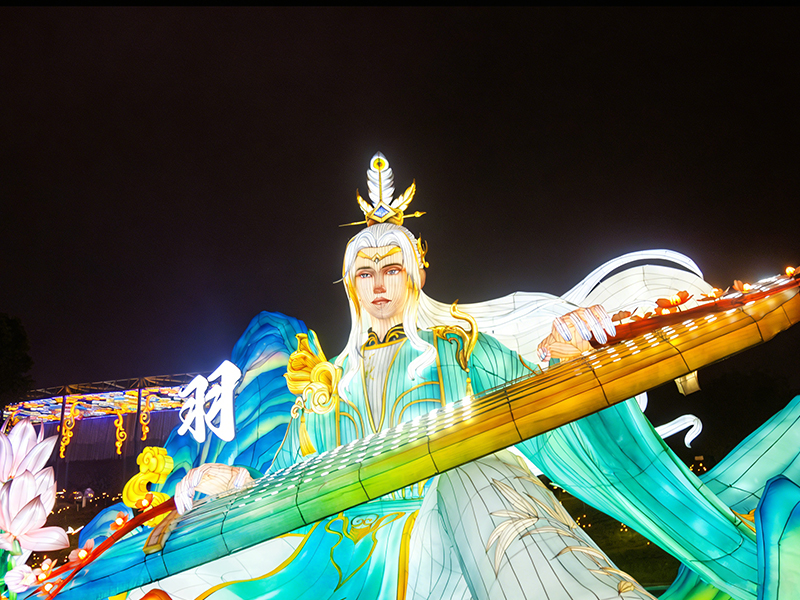 Ethereal immortal musician lantern with flowing white hair and turquoise robes, playing massive glowing guqin (Chinese zither). Serene expression embodies transcendence through artistic mastery. Mountains and lotus flowers create celestial atmosphere.