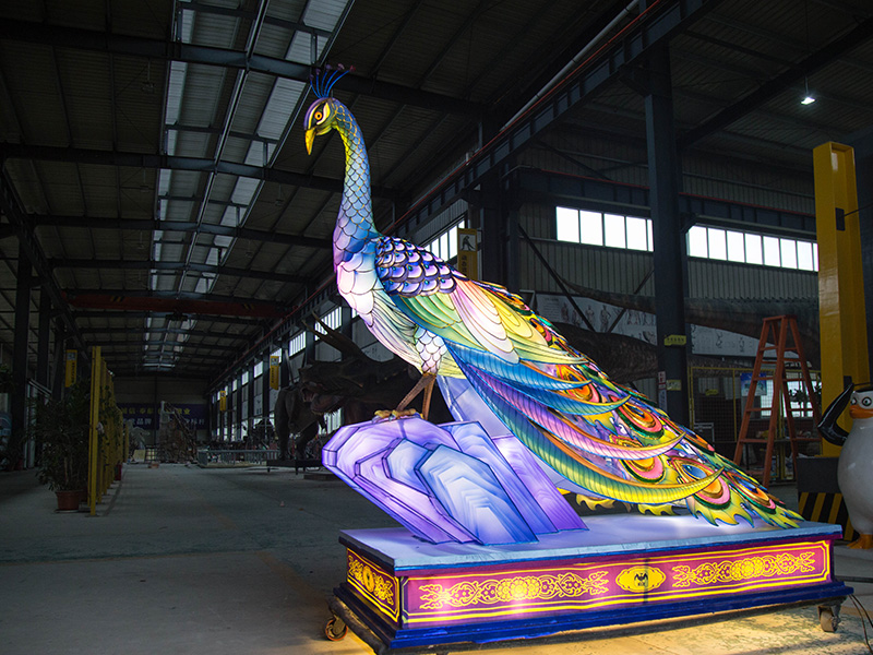 LED peacock lantern glowing at night with vibrant tail feather lights