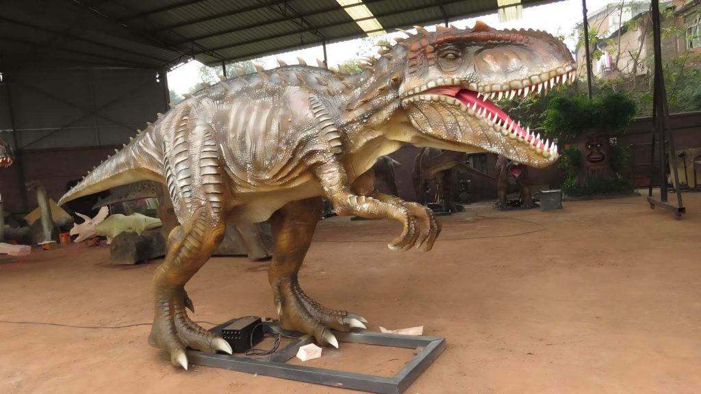 Life size animatronic T-Rex with realistic silicone skin texture displayed in factory workshop, showcasing premium craftsmanship for theme park installations.