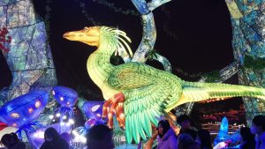 Illuminated animatronic dinosaur lantern sculpture glowing at Chinese lantern festival night display