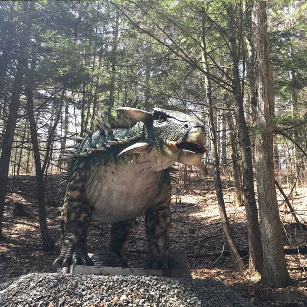 Animatronic Ankylosaurus in outdoor exhibit environment with natural background