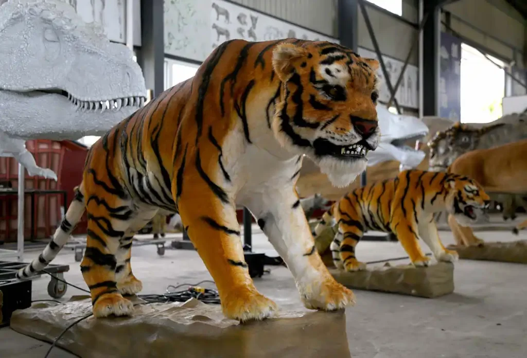 Animatronic tiger from side angle showing full body proportions and tail