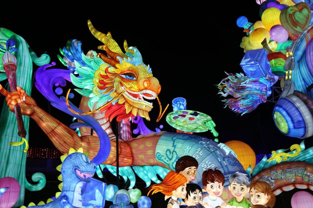 Children eating mooncakes at mid-autumn festival with lantern decoration