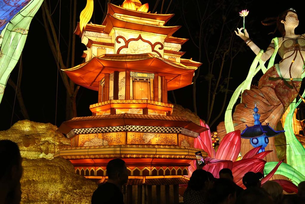 Feitian Apsara flying celestial maiden lantern with lotus, multi-tier pagoda and flowing silk ribbons at a cultural festival
