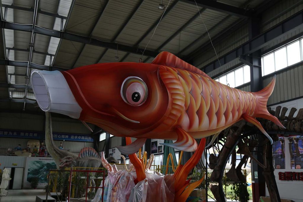 Japanese fish lantern inspired by traditional koinobori carp streamers, featuring red and white scales for sushi festivals and theme park Asian zones