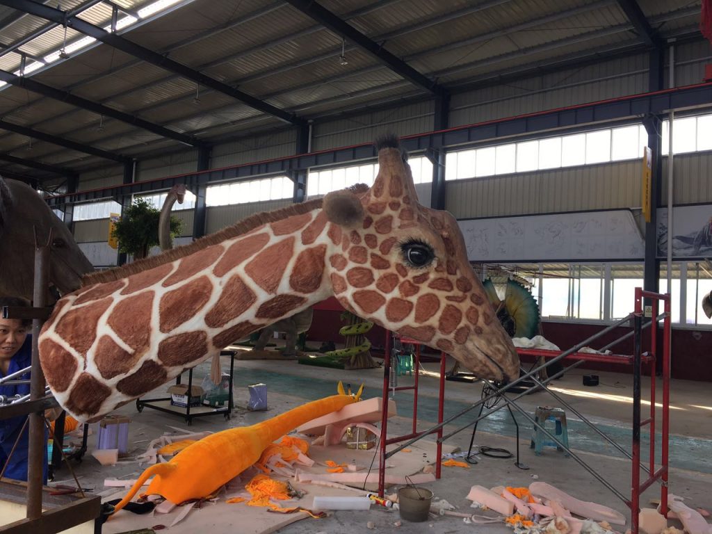 Interactive voice recognition animatronic giraffe with audio speaker and microphone for visitor-triggered voice conversation