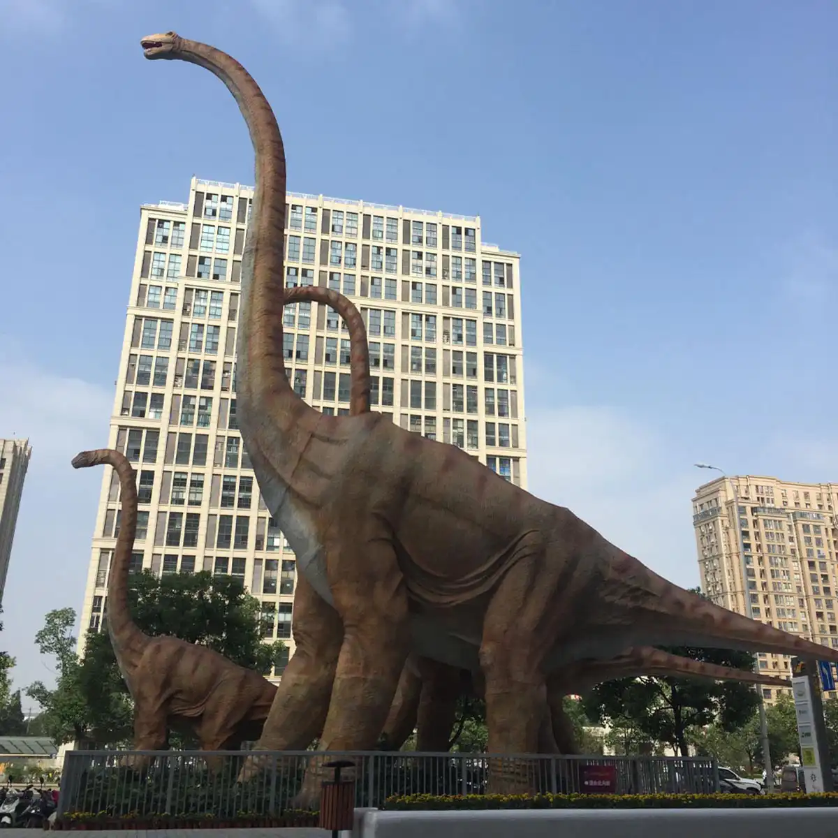 20-meter animatronic dinosaur for shopping mall towering over a Nanjing commercial center, visible from the street