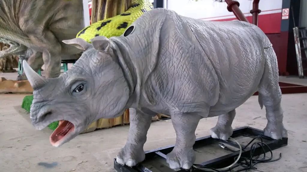 Animatronic white rhino side view showing body proportions and mouth opening motion