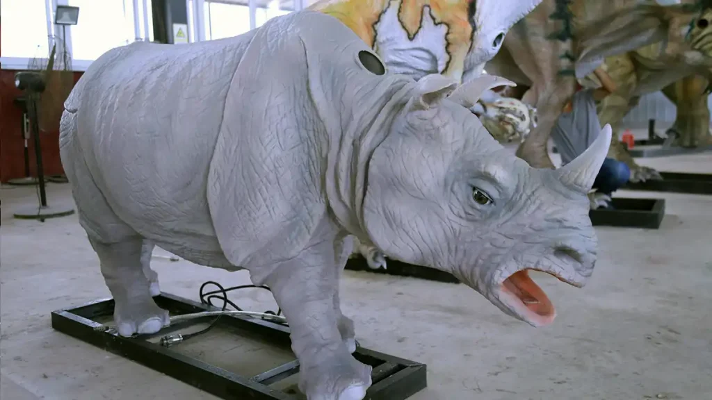 White rhino animatronic production side view showing high-density foam sculpture and base plate