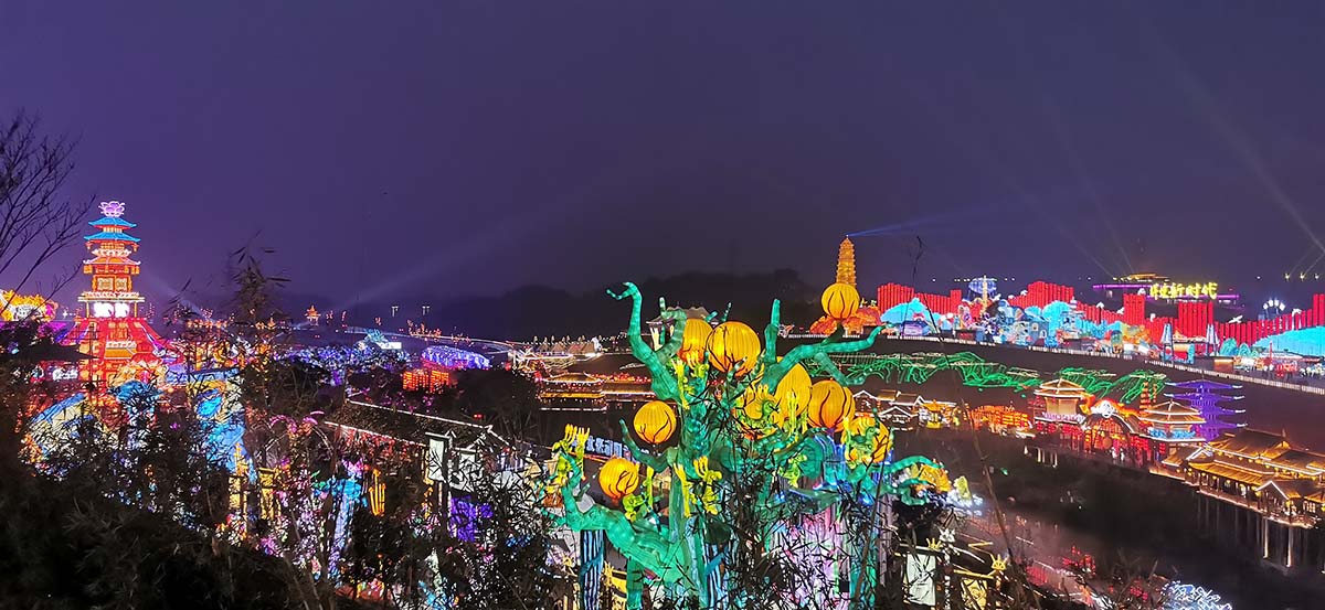 Panoramic aerial view of a Chinese New Year lantern festival with pagoda and water reflections