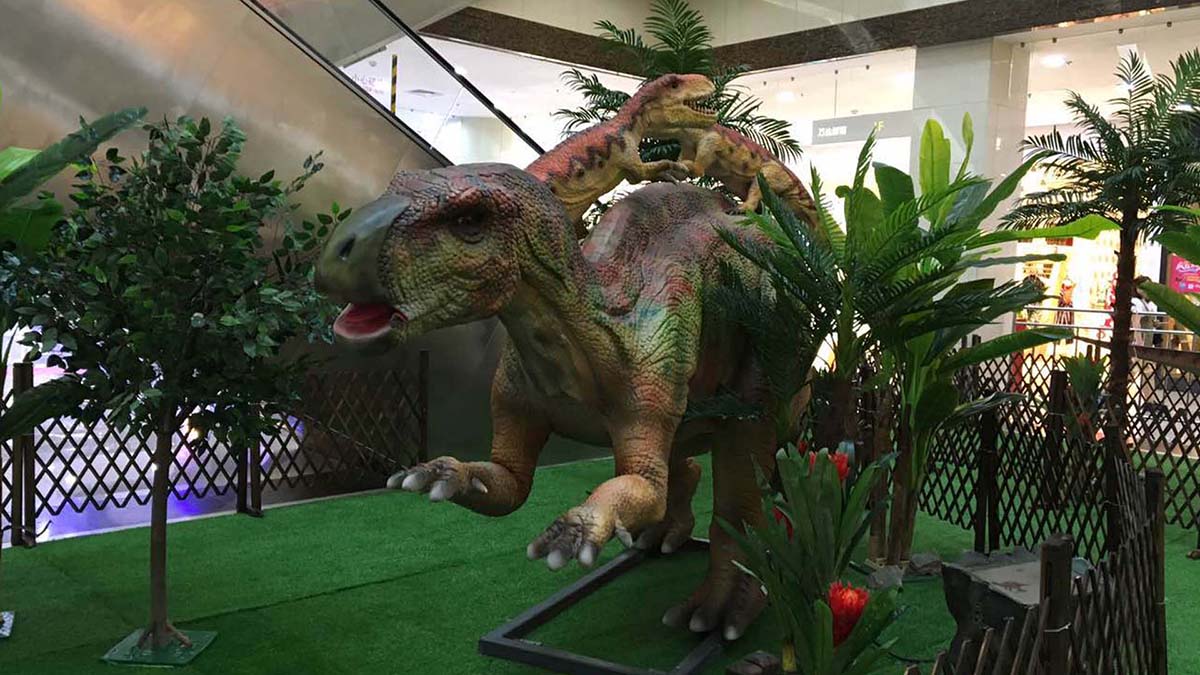Interactive animatronic dinosaur exhibit on display in a shopping mall, showing motion-triggered head and jaw responses