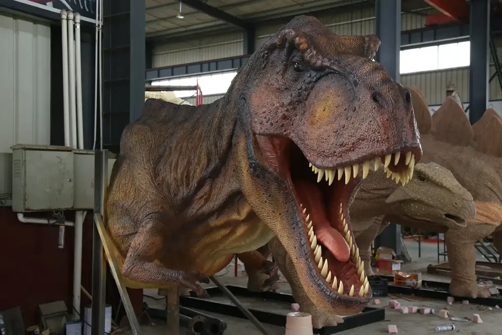 Motion-activated gesture-sensing T-Rex animatronic dinosaur in workshop, full body display with open mouth and roaring posture