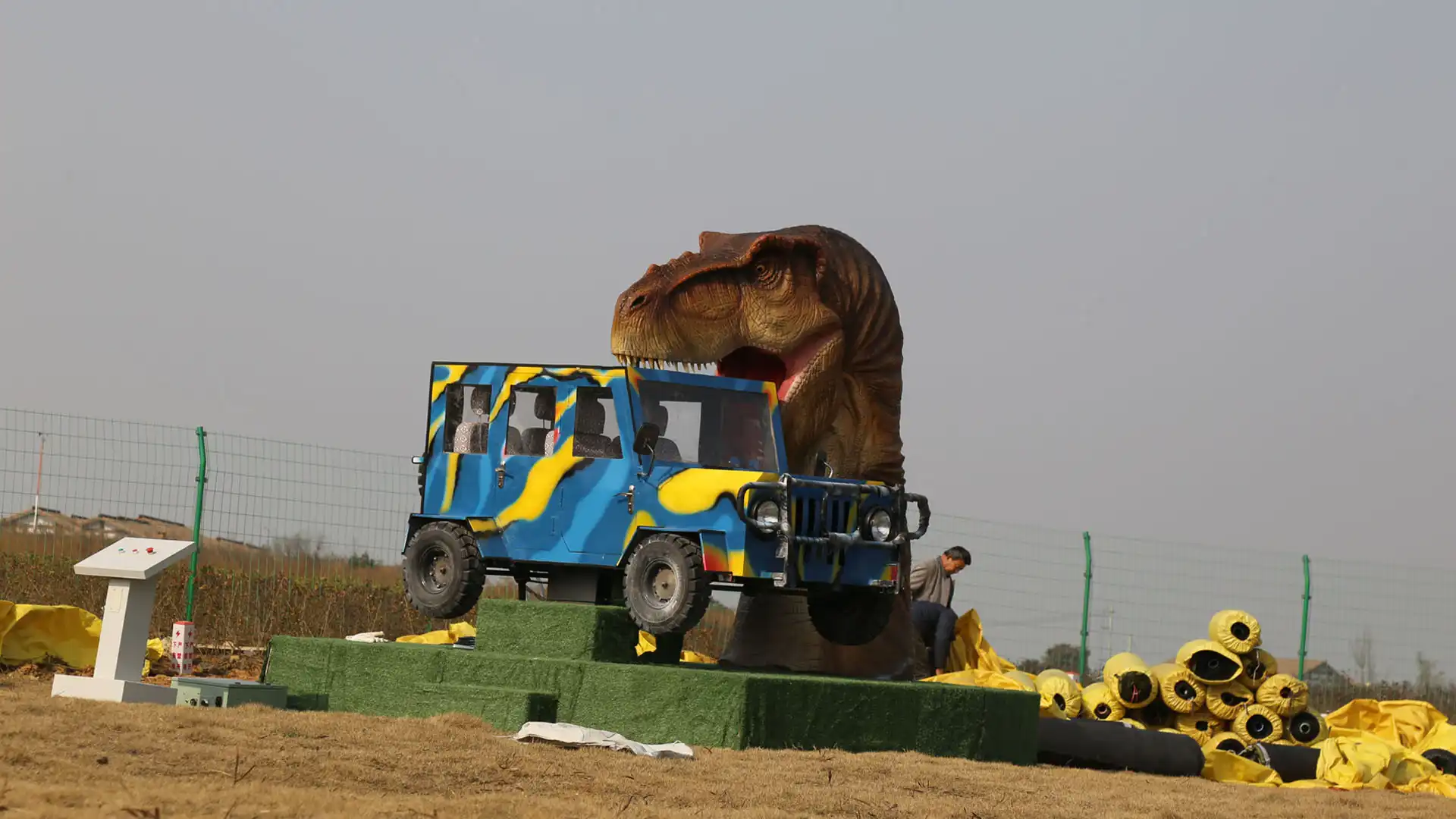Gesture-sensing interactive dinosaur products — Interactive T-Rex Bites Car photo ride with life-size animatronic Tyrannosaurus rex biting a 4x4 jeep cockpit