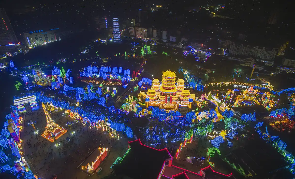 FestiveLanterns themed lantern festival aerial view — coordinated palace-and-grove illumination built as a single walkable night-time story