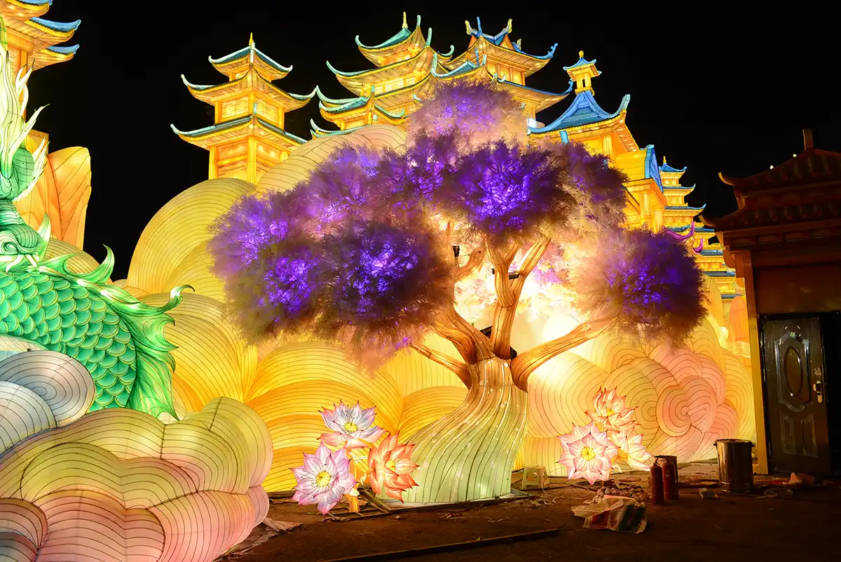 Custom lantern design process — elaborate illuminated palace lantern scene at a themed lantern festival