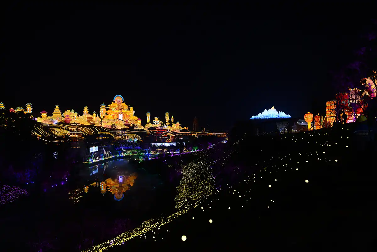 FestiveLanterns themed lantern festival at night with reflections in water — coordinated lights built as one immersive story spanning an entire venue
