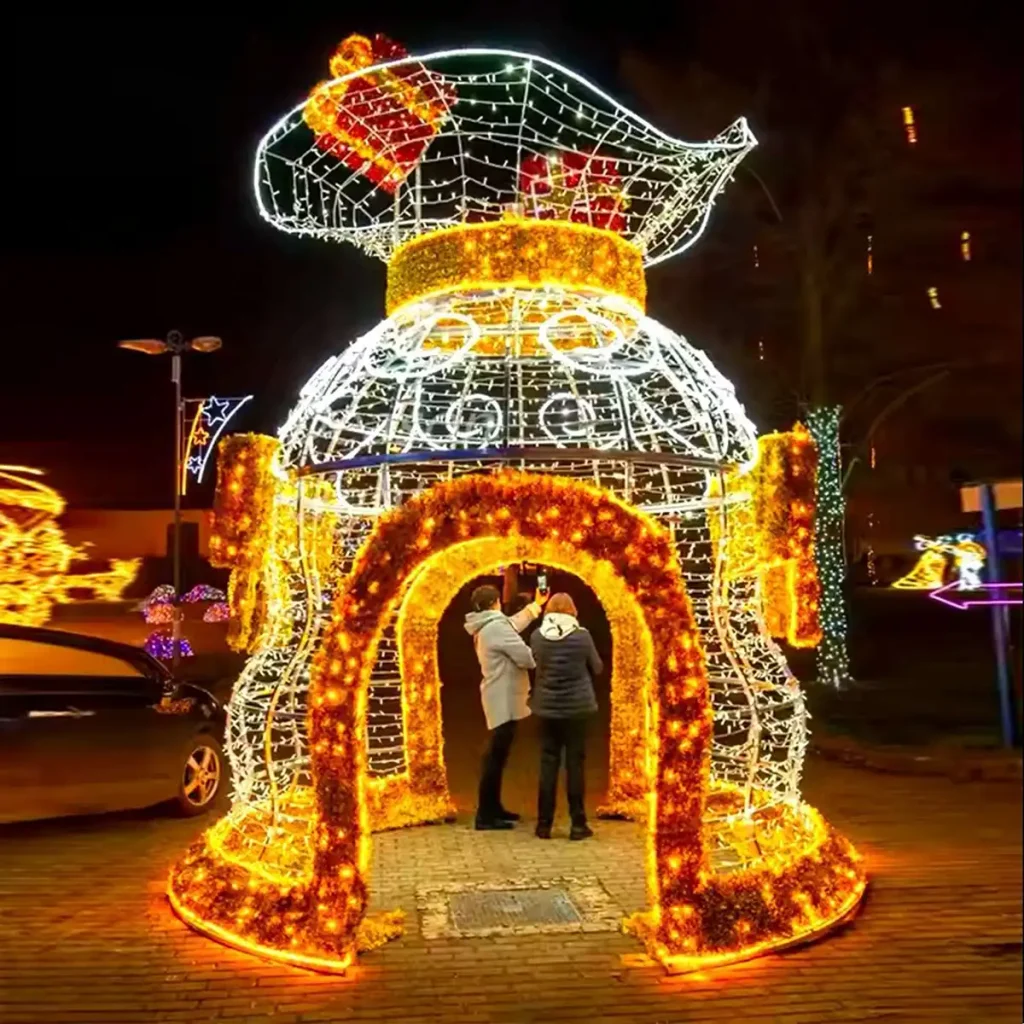 Walk-through Christmas light sculpture archway with reindeer, gift boxes and candy-cane illuminated columns