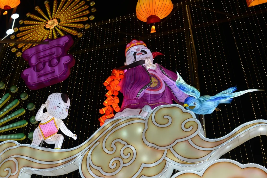 Alt Chinese New Year firecracker lantern scene with a robed figure holding firecrackers and a child covering his ears Title Chinese New Year Firecracker Lantern Scene