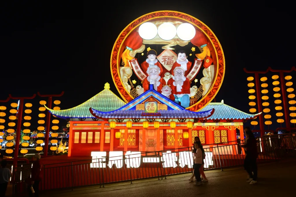 Chinese New Year greeting gate lantern with a family medallion, fu panel and red lantern colonnades