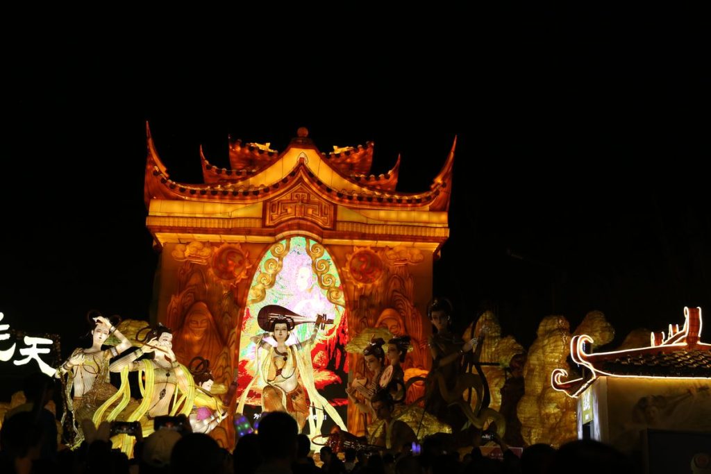 Flying apsaras lantern gateway with Dunhuang-style celestial figures at a Chinese lantern festival
