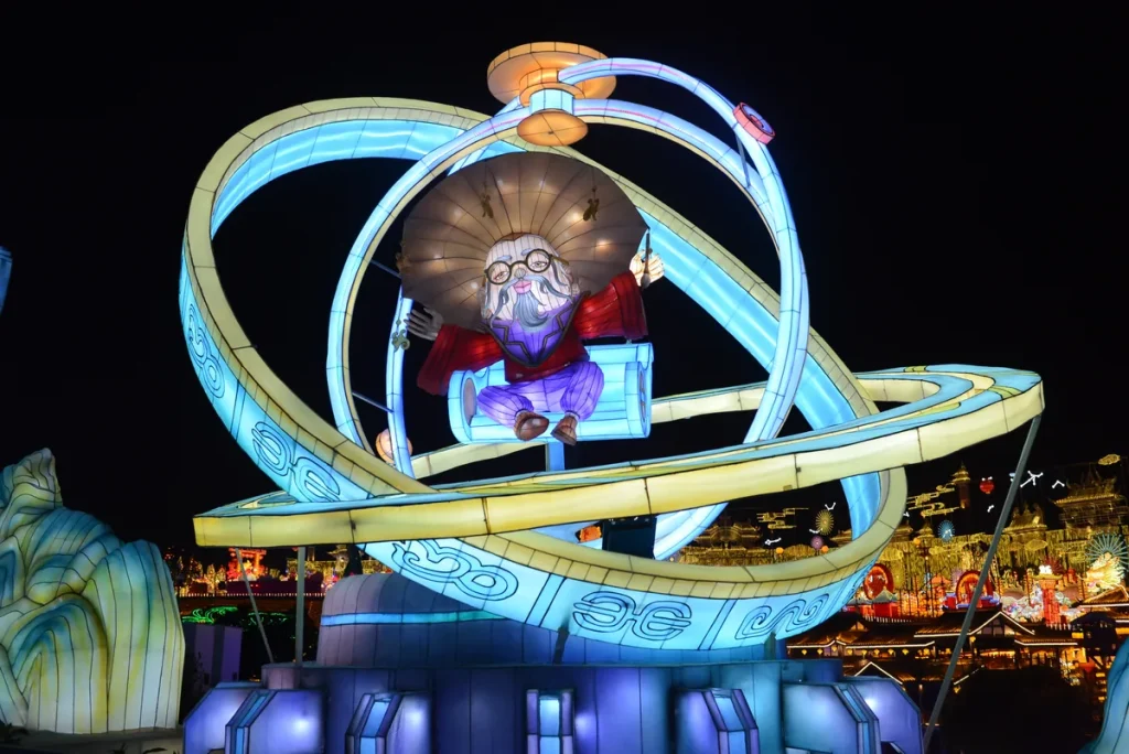 Chinese New Year firecracker lantern scene with a smiling robed figure raising a firecracker string, a child covering his ears, a blue bird and a purple fu plaque above a lit cloud base.