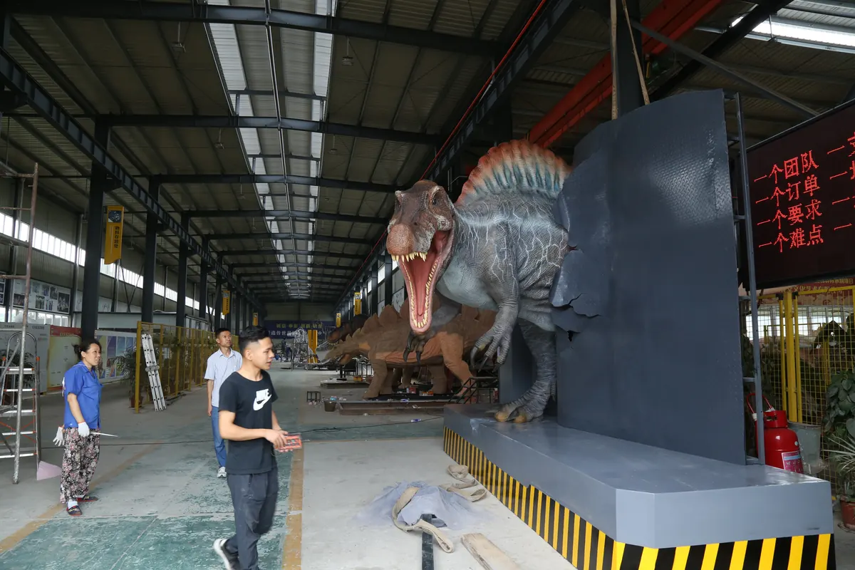 Production hall at the FestiveLanterns factory with several animatronic dinosaurs and lantern sculptures in progress