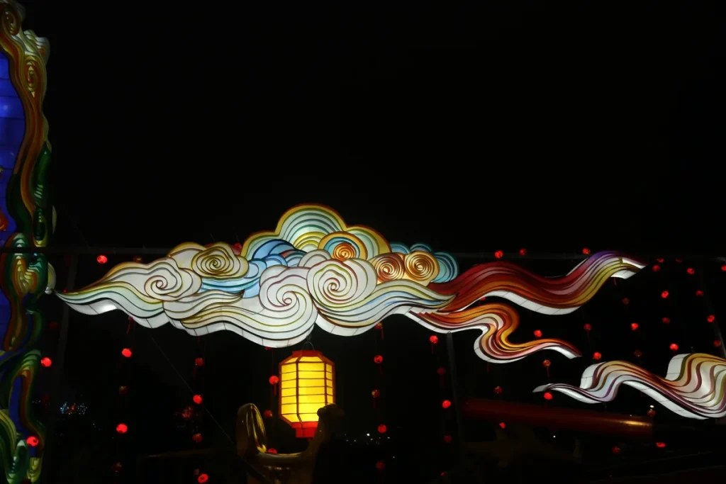 Cloud motif lantern archway with a layered silk cloud scroll span, ruyi crest and hanging red lanterns