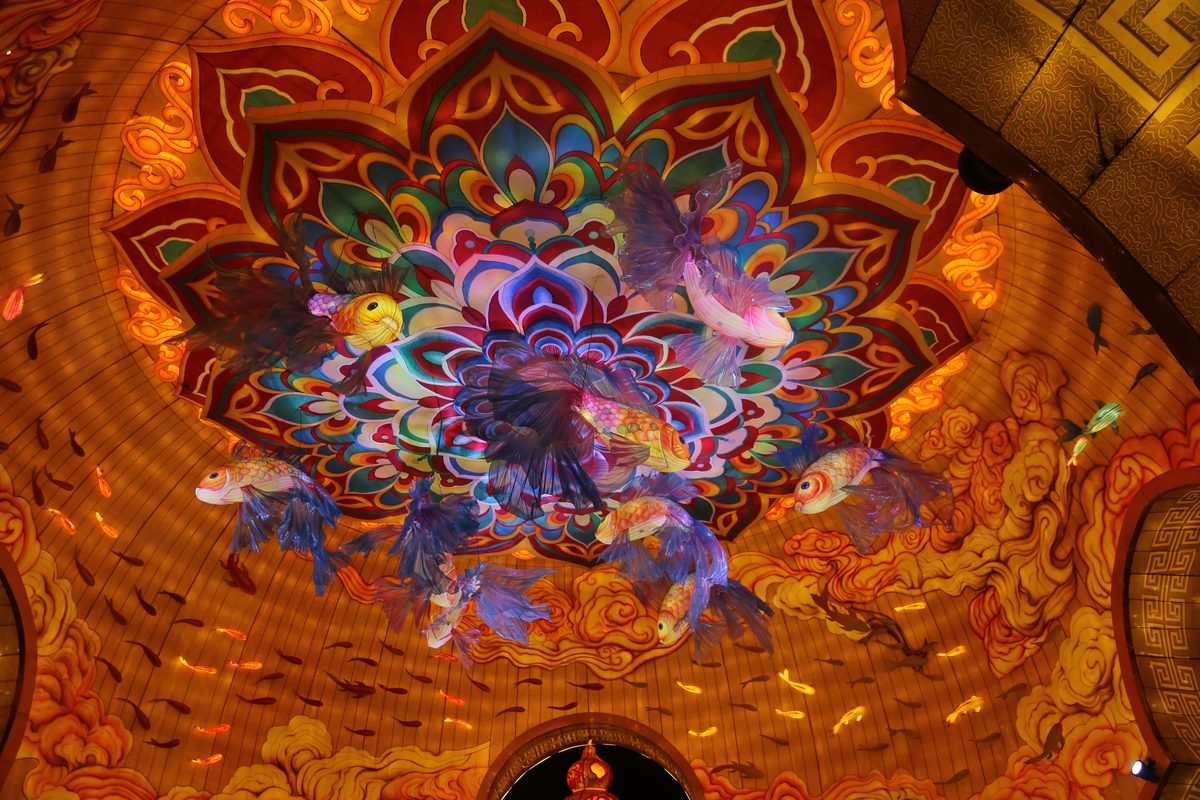 Indoor ceiling lantern installation with a painted lotus medallion and suspended elements