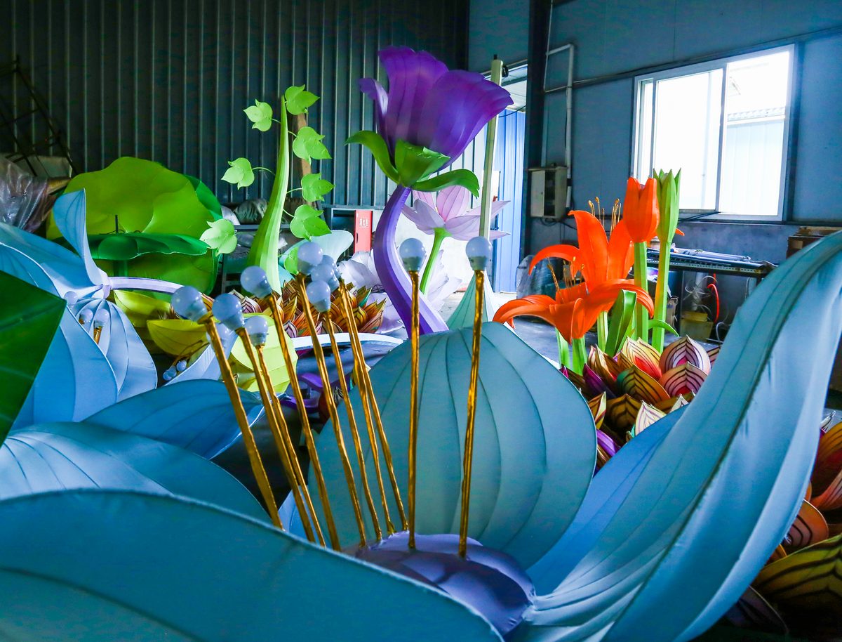 Part-finished lantern flowers and leaves stacked in a lantern factory workshop